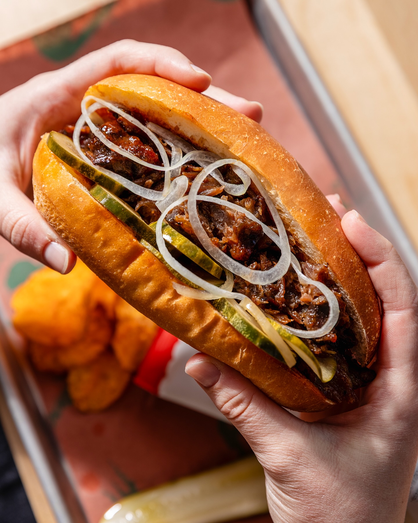 Brisket sandwich with pickles and shaved onion