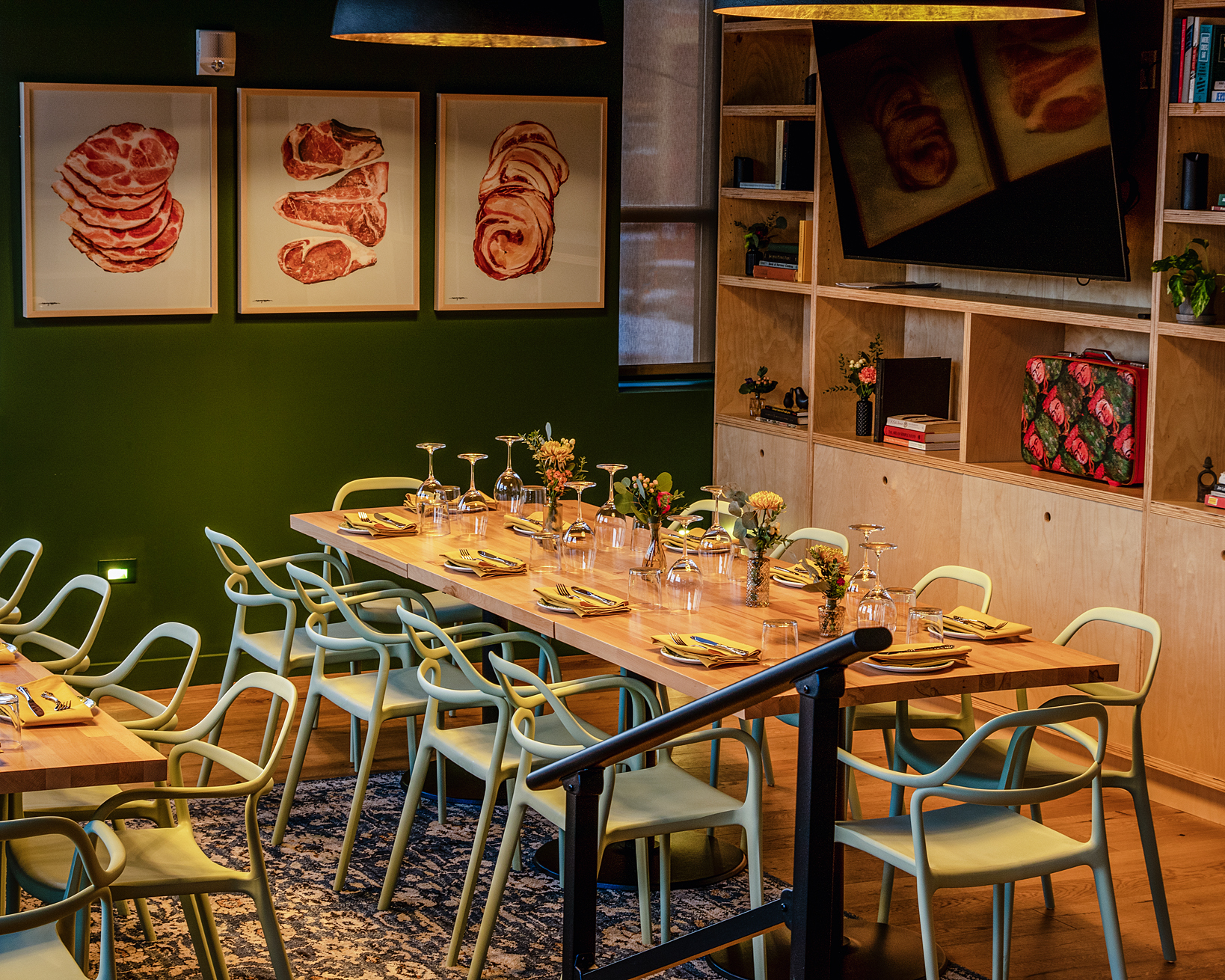 The Green Room with deep green walls and communal tables