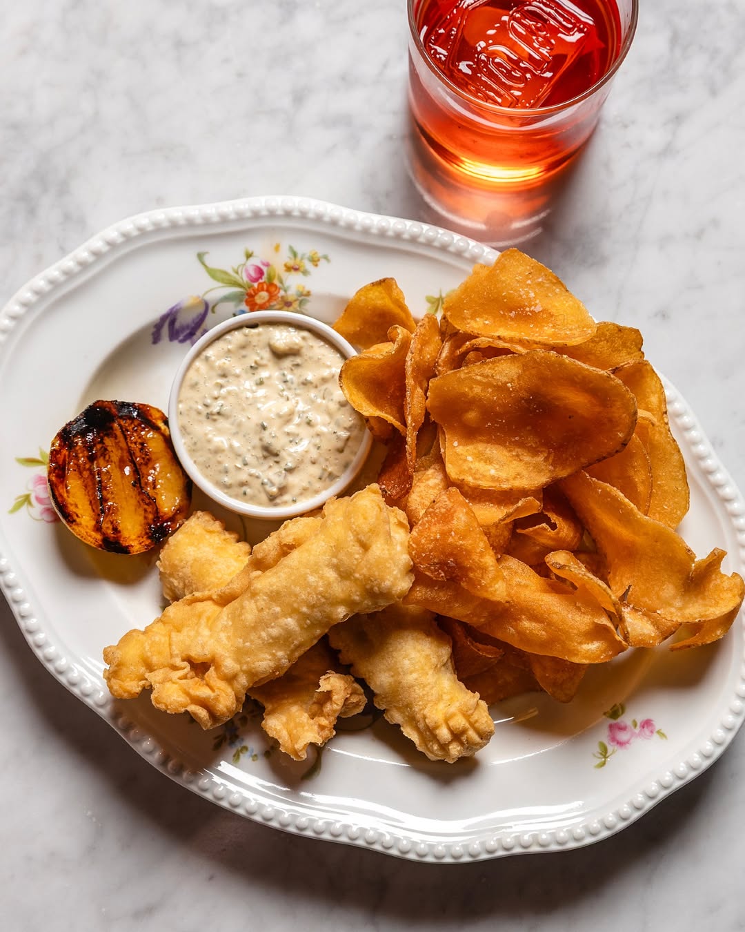 Fish and chips with tartar and burnt lemon